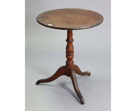 A 19th century oak tripod table with a circular tilt-top, &amp; on vase-turned centre column &amp; three splay legs, 22” diam