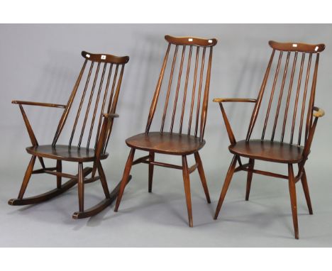 An Ercol spindle-back rocking chair with hard seat, &amp; two similar dining chairs.