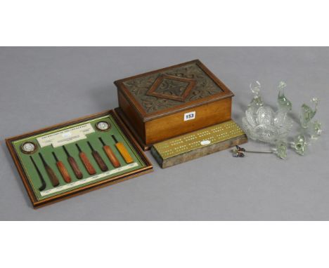 A carved walnut trinket box with a hinged lift-lid, 10” wide; together with a brass-mounted cribbage board; a reproduction di