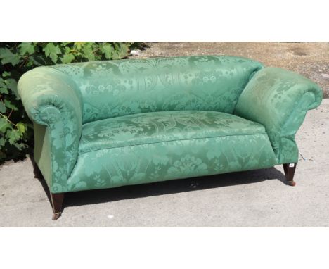 A late 19th/early 20th century two-seater drop-end settee upholstered green foliate damask, &amp; on short square tapered leg