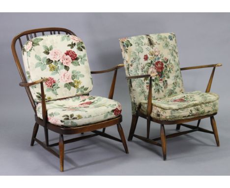 An Ercol spindle-back easy chair with loose cushion to the seat &amp; back, on round tapered legs; &amp; a similar easy chair