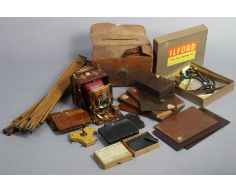 An early 20th century Lizars “Challenge” mahogany folding plate camera with nine plates; a tripod stand, case; &amp; various 