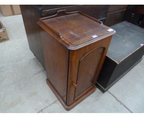 A Victorian mahogany pot cupboard enclosed by an arch panel door