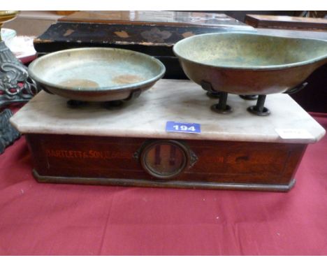 Weighing scales by Bartlett & Son, Bristol with brass pans above marble stage. 14.5'' w