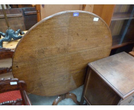 A George III oak snap-top tripod table. 34'' diameter