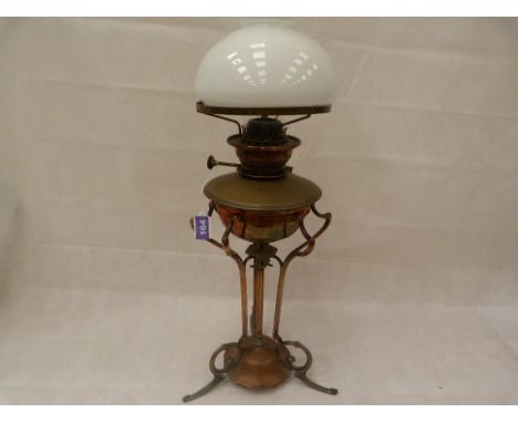 An early 20th Century Art Nouveau Hinks copper oil lamp No 3634, on stylised base. 25'' high to top of shade