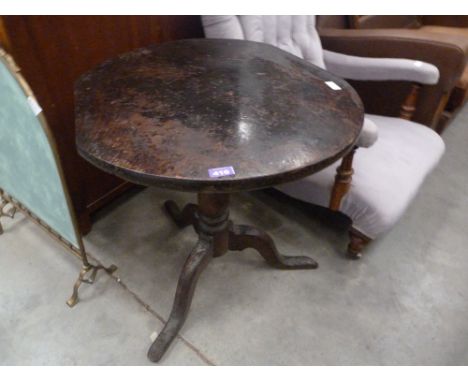 An 18th Century primitive oak tripod table with thick top. 26'' diam (losses)