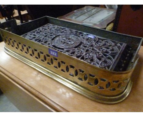 A brass fire curb and a decorative french enamel stove top