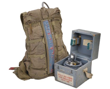 * Parachute. Post WWII military parachute, green canvas rucksack with large printed label giving instructions for use, togeth
