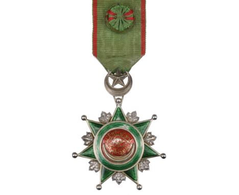 * Ottoman Empire, Order of Osmania, Fourth Class breast badge, silver, silver-gilt, and enamel, very fine with some loss of g