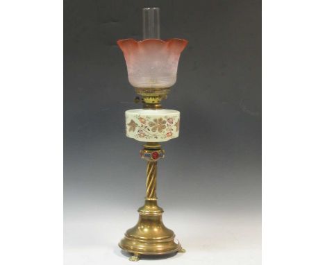 A Victorian brass oil lamp, the ecclesiastical style base with opaque glass reservoir, 72cm high; together with a figural oil