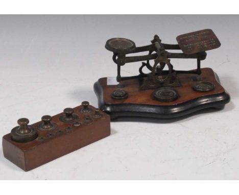 A set of brass postal scales and weights