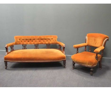 A late Victorian dralon-covered parlour settee 72 x 148 x 62cm and an armchair on casters in similar fabric stamped 'K &amp;S