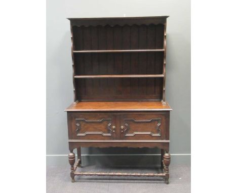 A dark oak shelf back dresser, 194 x 121 x 47cm and 1930s oak two door china cabinet, 131 x 84 x 32cm (2)