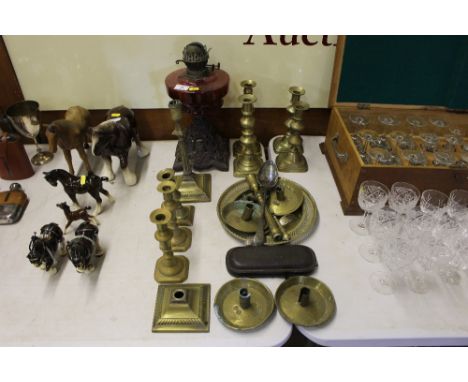 A Victorian oil lamp with cranberry glass reservoir together with a quantity of 19th Century brass candlesticks etc.