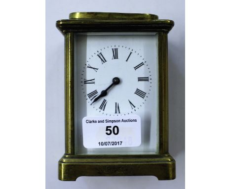 A brass cased carriage clock with key