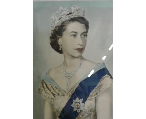 A gilt framed portrait print depicting Queen Elizabeth II