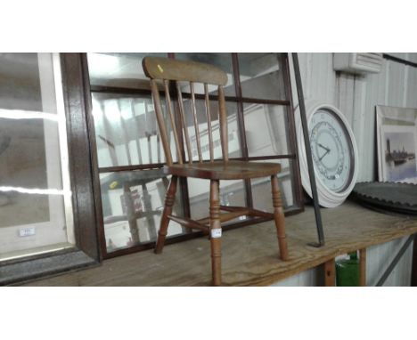 A child's elm seated stick back chair