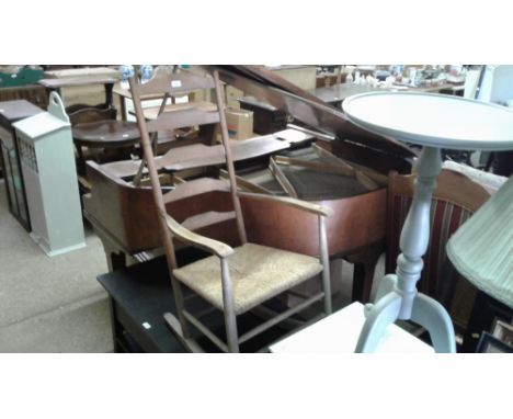 An oak ladder back and rush seated rocking chair