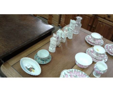 Four various Victorian figures; a glass decanter - lacking stopper; a floral decorated teacup and saucer and a small German d