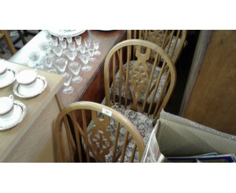 A set of four stick and wheel back kitchen chairs