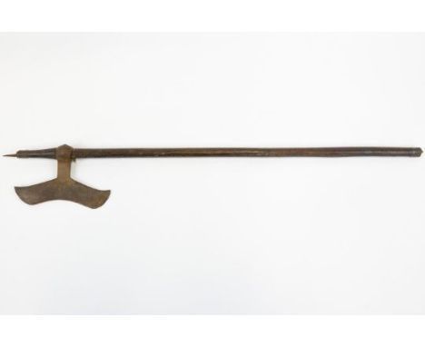 An Indian axe from Chota Nagpur, moustache shaped blade 8" with traces of simple decoration, on its plain wood haft with smal