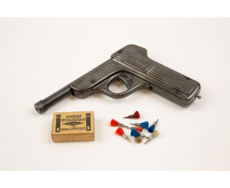 A .177" Diana first model tin plate air pistol, embossed "Diana" above the trigger guard, the ribbed grips bearing figure of 