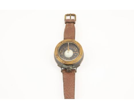 A WWI Royal Flying Corps brass wrist compass, the rim marked "Patt. 261, No 1241B/55", with leather strap and buckle. GC (the