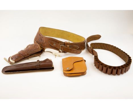 A Mexican tooled leather gun belt and open top holster, decorated overall with foliate scrolls, stamped "Made in Mexico" VGC;