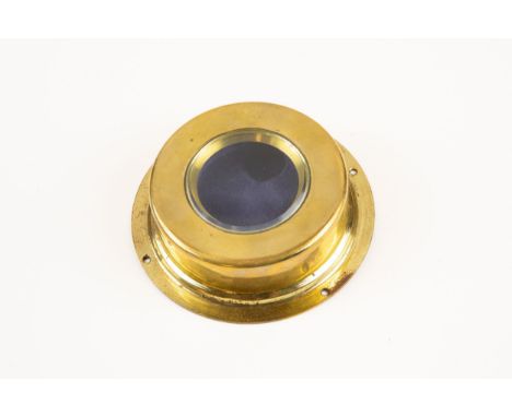 A WWI aircraft brass cockpit clock holder, with beveled glass window, the front released by a spring button, the back marked 