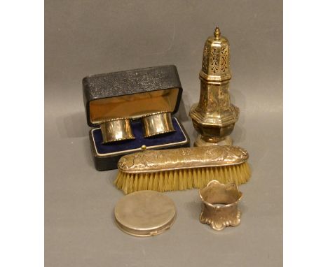 A London Silver Sugar Sifter, Together With A Pair Of Silver Cased Napkin Rings, a silver backed brush, a silver compact and 