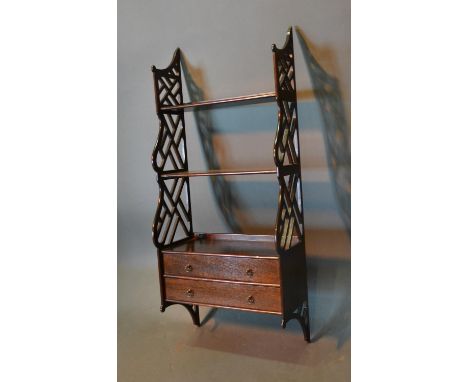 A Mahogany Hanging Wall Shelf With Pierced Shaped Sides and two drawers with brass handles, 43cm wide and 98cm tall 