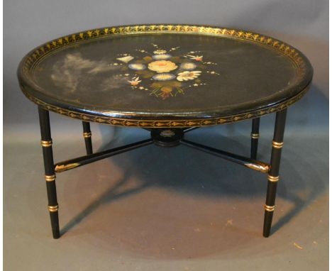 An Oval Lacquered Tray Converted To A Coffee Table, with ring turned tapering legs and crossover stretcher, 75cm by 61cm 