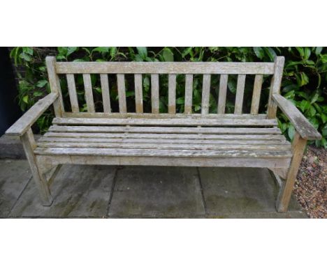 A Teak Garden Bench With Slated Back And Seat, raised upon square legs with stretchers, 159cm wide 