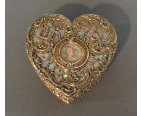 An Imported Silver Gilt Box In The Form Of A Heart, the mother of pearl cover with silver scrolls and with central miniature 