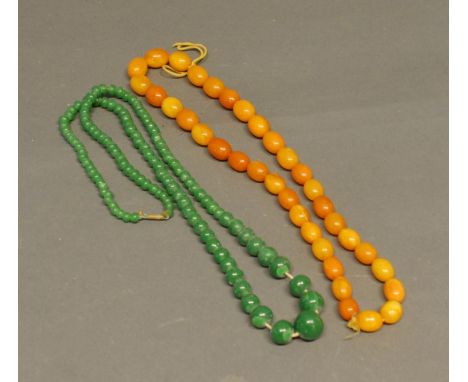 A Graduated Scotch Amber Bead Necklace, together with a Jade necklace 