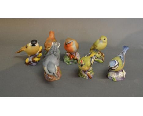 A Royal Worcester Porcelain Model Of A Robin, together with another of a Wood Warbler, another Blue Tit, another of a Wren, a