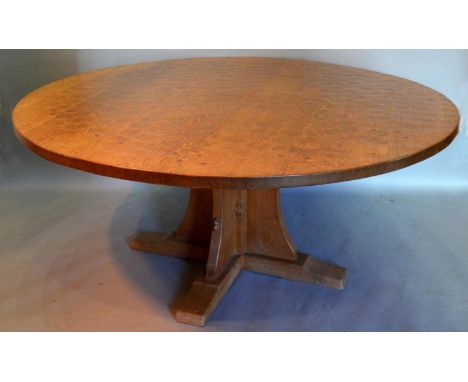 A Robert (Mouseman) Thompson Of Kilburn  Large Circular Heavy Oak Dining Table, the adze carved top above a quadruped base wi