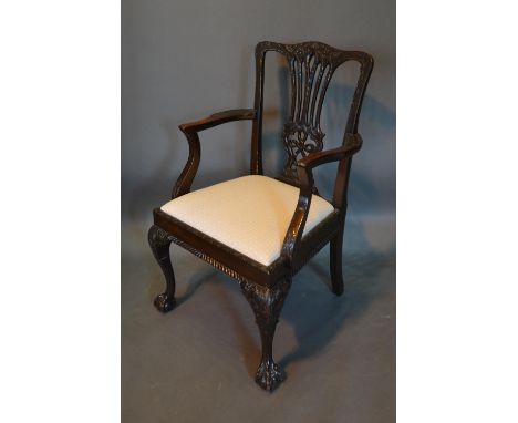 A 19th Century Mahogany Chippendale Style Armchair, the carved pierced back above a drop in seat with shaped arms, raised upo