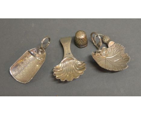 A George III Silver Caddy Spoon Of Scallop Form By Hester Bateman, together with two other silver caddy spoons and a silver t