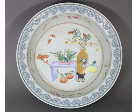 A Chinese famille rose porcelain large basin decorated with precious objects &amp; flowers, a band of ruyi heads to the flare