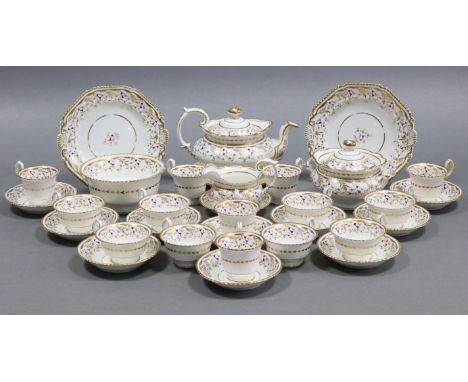 An early 19th century English porcelain thirty-two piece part tea &amp; coffee service with scrolling gilt &amp; puce floral 