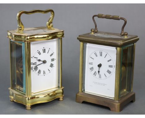 A French gilt-brass carriage timepiece with serpentine sides, white enamel dial with black roman numerals, 4¾” high; &amp; an
