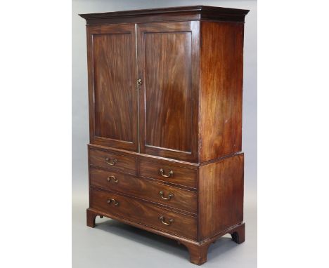 A George III flame mahogany linen press, with moulded cavetto cornice above five sliding trays enclosed by pair of fielded pa