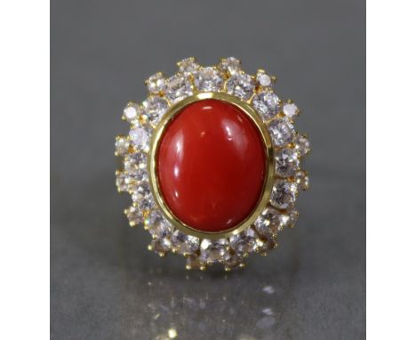 A carnelian &amp; diamond ring, the oval cabochon set with in a border of thirty two small graduated diamonds, to a yellow me