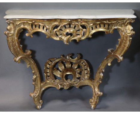 A LOUIS XV-STYLE CARVED GILTWOOD CONSOLE TABLE, of bombé form with pierced central cartouche to the frieze &amp; undertier, o