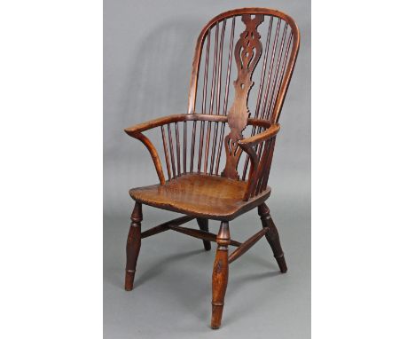 A 19th century large yew &amp; elm Windsor elbow chair with shaped centre splat to the high stick-back, with curved arms &amp