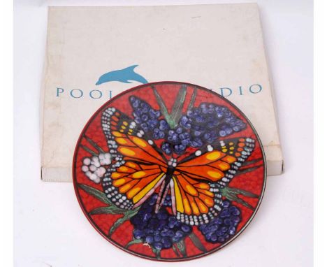 Poole Pottery charger with butterfly design on red ground, the base with factory mark, limited edition 3/100, designed by TM,