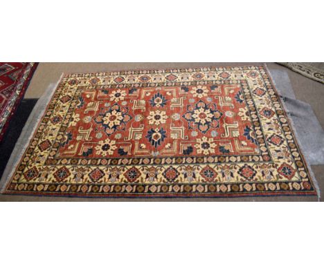 Modern Caucasian style carpet, central panel of geometric lozenges, foliage etc, mainly rust field, 152 x 216cm