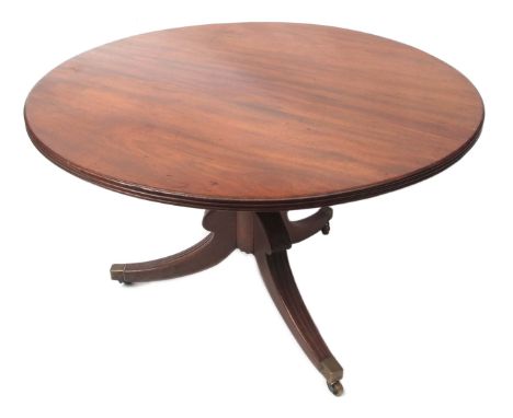 Regency period mahogany circular dining table, with reeded edge, raised on lobed baluster support terminating in a tripod bas